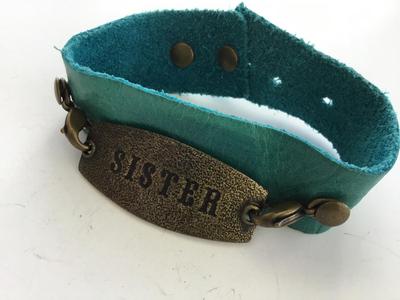 LE marked snap on leather type sister bracelet