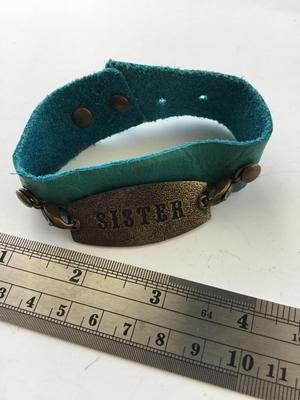 LE marked snap on leather type sister bracelet
