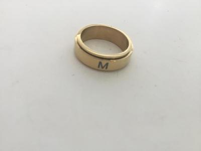 M. Marked gold tone ring