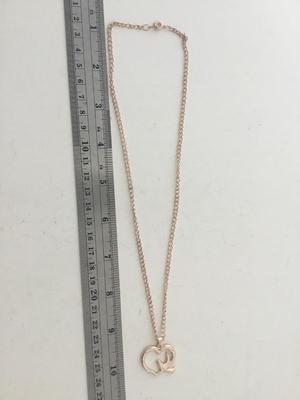 Gold tone bird and heart necklace