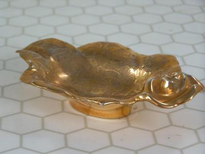 Small gold plated ceramic bowl, or maybe ash tray. About 5" long.
