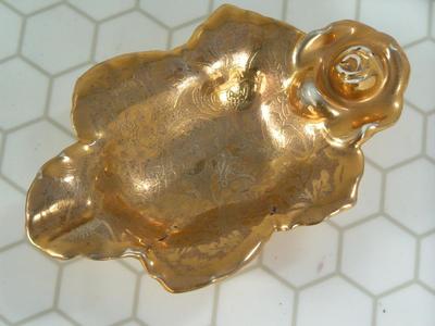 Small gold plated ceramic bowl, or maybe ash tray. About 5" long.