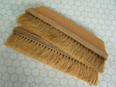 A pair of wall paper installer brushes