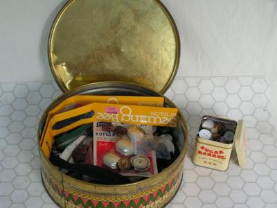 Two tins full of buttons & zippers & stuff