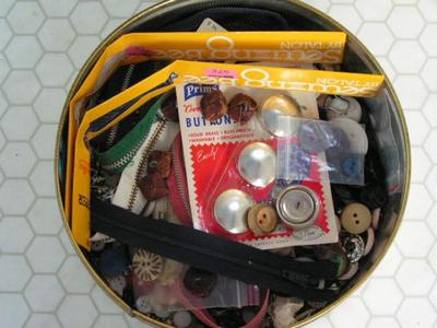 Two tins full of buttons & zippers & stuff