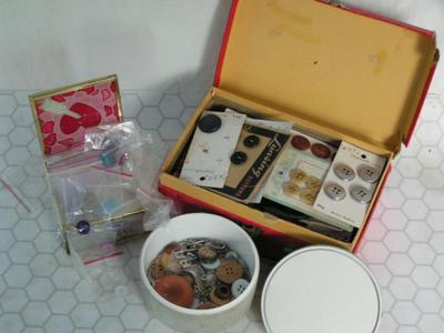 Three containers full of buttons