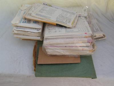 A pile of sewing patterns in a box