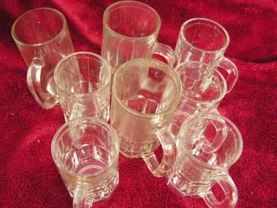 A group of small clear glass mugs.