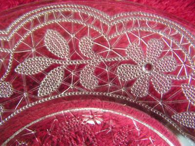 Clear glass sandwich/salad plate Poesy pattern w/ footed bottom.