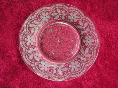 Clear glass sandwich/salad plate Poesy pattern w/ footed bottom.