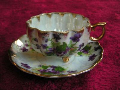 Vintage Norcrest porcelain 3-footed teacup with saucer. Pearlescent finish
