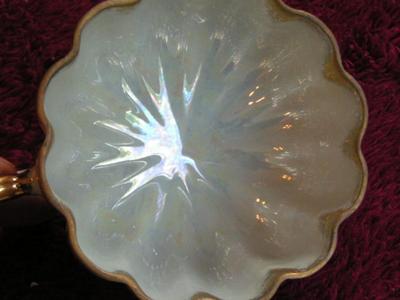 Vintage Norcrest porcelain 3-footed teacup with saucer. Pearlescent finish