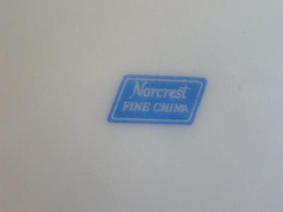 Vintage Norcrest porcelain 3-footed teacup with saucer. Pearlescent finish