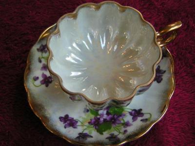 Vintage Norcrest porcelain 3-footed teacup with saucer. Pearlescent finish