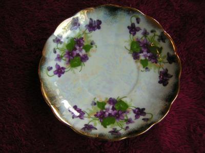 Vintage Norcrest porcelain 3-footed teacup with saucer. Pearlescent finish