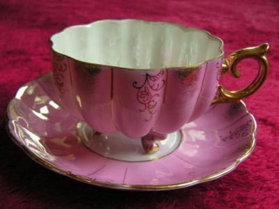 Vintage porcelain (Japanese?) 3-footed teacup and saucer set.