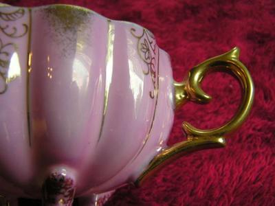 Vintage porcelain (Japanese?) 3-footed teacup and saucer set.
