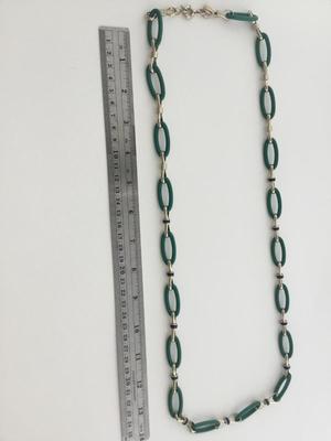 Gold tone green fashion T marked necklace