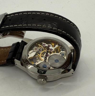 Sale Photo Thumbnail #7: Swiss made, stainless steel back.  Black leather band, luminous hands.  Manual winding, tested, runs as expected.  Good condition, includes wood and felt storage box.