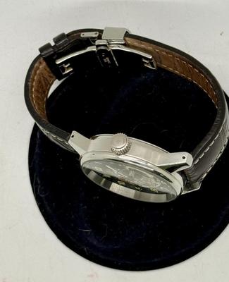 Sale Photo Thumbnail #2: Swiss made, stainless steel back.  Black leather band, luminous hands.  Manual winding, tested, runs as expected.  Good condition, includes wood and felt storage box.