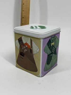 Sale Photo Thumbnail #516: Collectible Metal Tin with snap-down lid.  Images of 4 different Girl Scout uniforms. No dents or scratches.