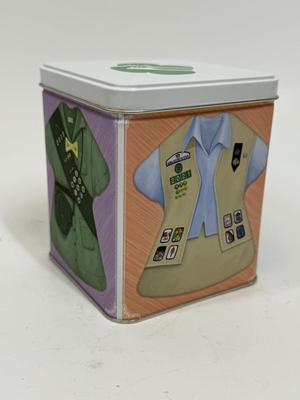 Sale Photo Thumbnail #512: Collectible Metal Tin with snap-down lid.  Images of 4 different Girl Scout uniforms. No dents or scratches.