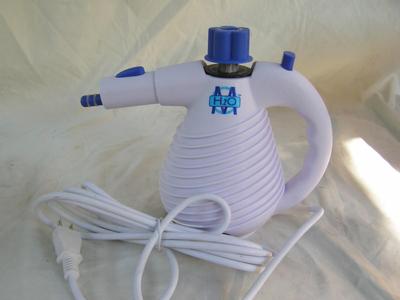 Portable hand held steam cleaner. Appears new in box/unused