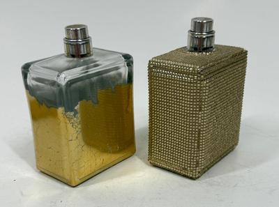 Sale Photo Thumbnail #221: Viva La Juicy Limited Edition 3.4oz Parfum Spray with gold beaded glass bottle (still contains some perfume), and another Viva La Juicy Limited Edition 3.4oz Parfum Spray with gold gilt glass bottle (worn/crackled finish), that one appears to be empty.