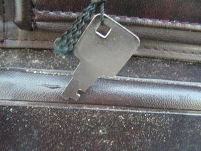 Old thin line style brief case, w/key. Fair condition.