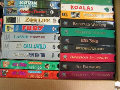 A box full of VHS movies, 38 of them