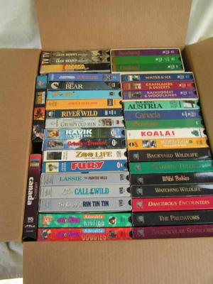 A box full of VHS movies, 38 of them