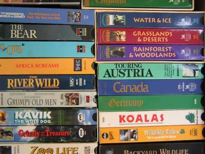 A box full of VHS movies, 38 of them