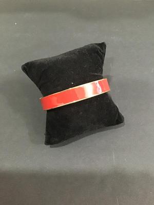 Gold tone hinged bracelet with red enamel