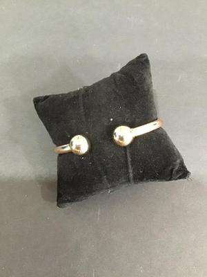 Gold tone spring hinged bracelet