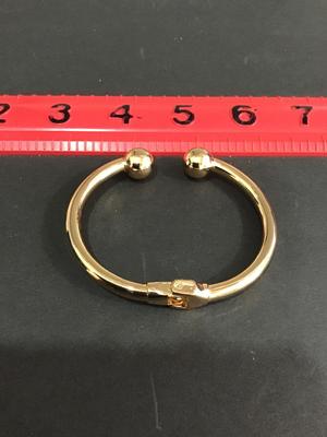 Gold tone spring hinged bracelet