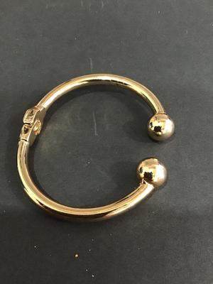 Gold tone spring hinged bracelet
