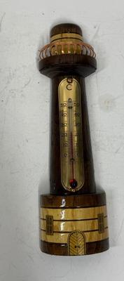 Sale Photo Thumbnail #101: Polished and stained wood lighthouse with brass and copper accents. Attached glass thermometer measures from 0 degrees C to 50 degrees C. Good condition, approx. 8" tall.