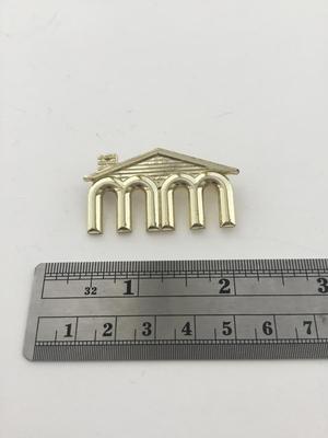 Gold tone MM roof brooch vintage
