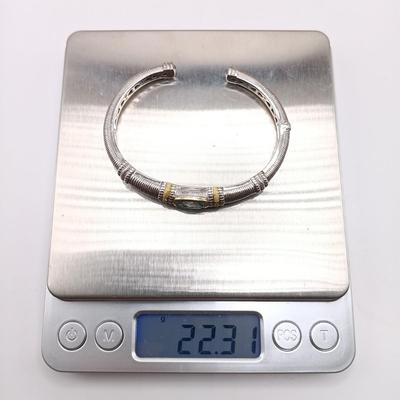 LOT 310: Judith Ripka 925 Sterling Silver and 18K Gold Cuff Bracelet with Blue Topaz Center