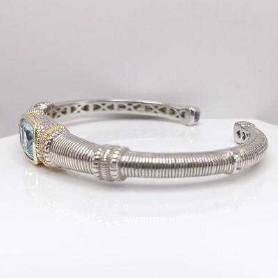 LOT 310: Judith Ripka 925 Sterling Silver and 18K Gold Cuff Bracelet with Blue Topaz Center