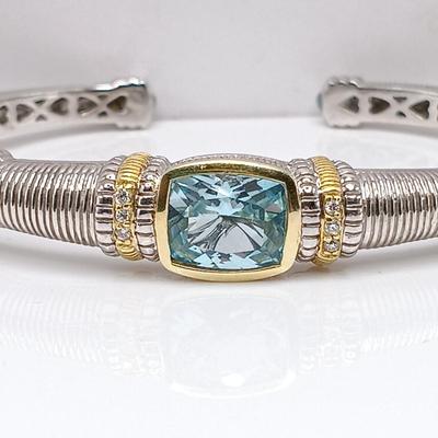 LOT 310: Judith Ripka 925 Sterling Silver and 18K Gold Cuff Bracelet with Blue Topaz Center
