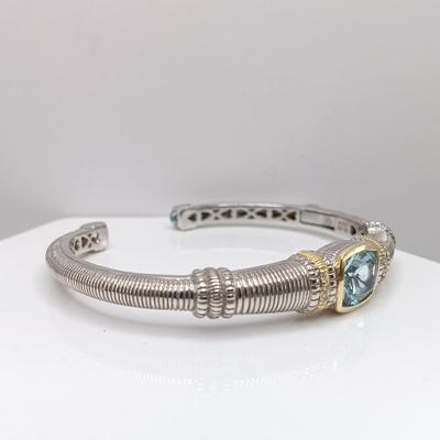 LOT 310: Judith Ripka 925 Sterling Silver and 18K Gold Cuff Bracelet with Blue Topaz Center