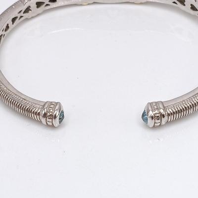 LOT 310: Judith Ripka 925 Sterling Silver and 18K Gold Cuff Bracelet with Blue Topaz Center