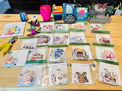A BUNCH OF NICELY SORTED STICKERS, HOLE PUNCH, MUSIC BULLET SPEAKER, MAGNETS, SMALL ORGANIZERS AND MORE!