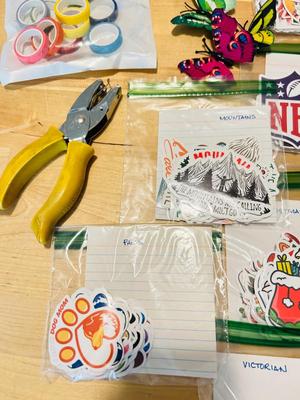 A BUNCH OF NICELY SORTED STICKERS, HOLE PUNCH, MUSIC BULLET SPEAKER, MAGNETS, SMALL ORGANIZERS AND MORE!