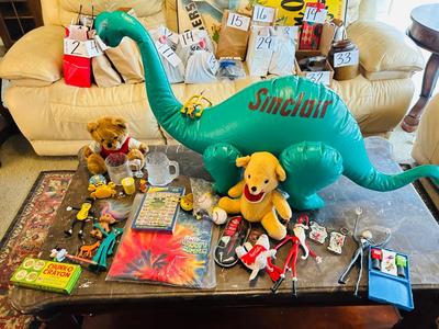 A VARIETY OF DIFFERENT TOYS AND OTHER ITEMS EVEN AN INFLATABLE SINCLAIR DINOSAUR