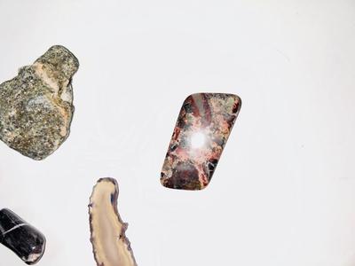 LARGE PIECE OF PETRIFIED WOOD, CRYSTAL, AND OTHER POLISHED STONES