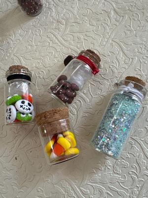 Assortment of little vials with polymer clay figurines