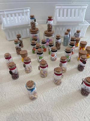 Assortment of little vials with polymer clay figurines