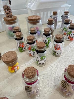 Assortment of little vials with polymer clay figurines